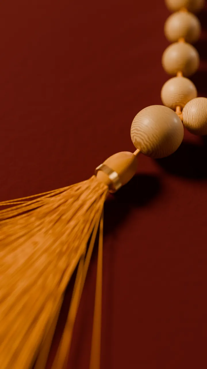 The sumeru and tassel of a sandalwood mala