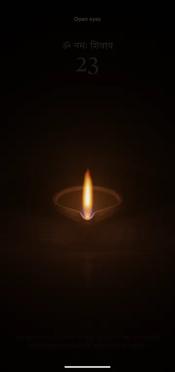 Eyes-closed mode: a clay diya in the dark, the count faintly above it